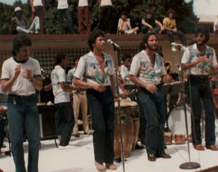 Orquesta La Solución on stage with salsa singer Frankie Ruiz