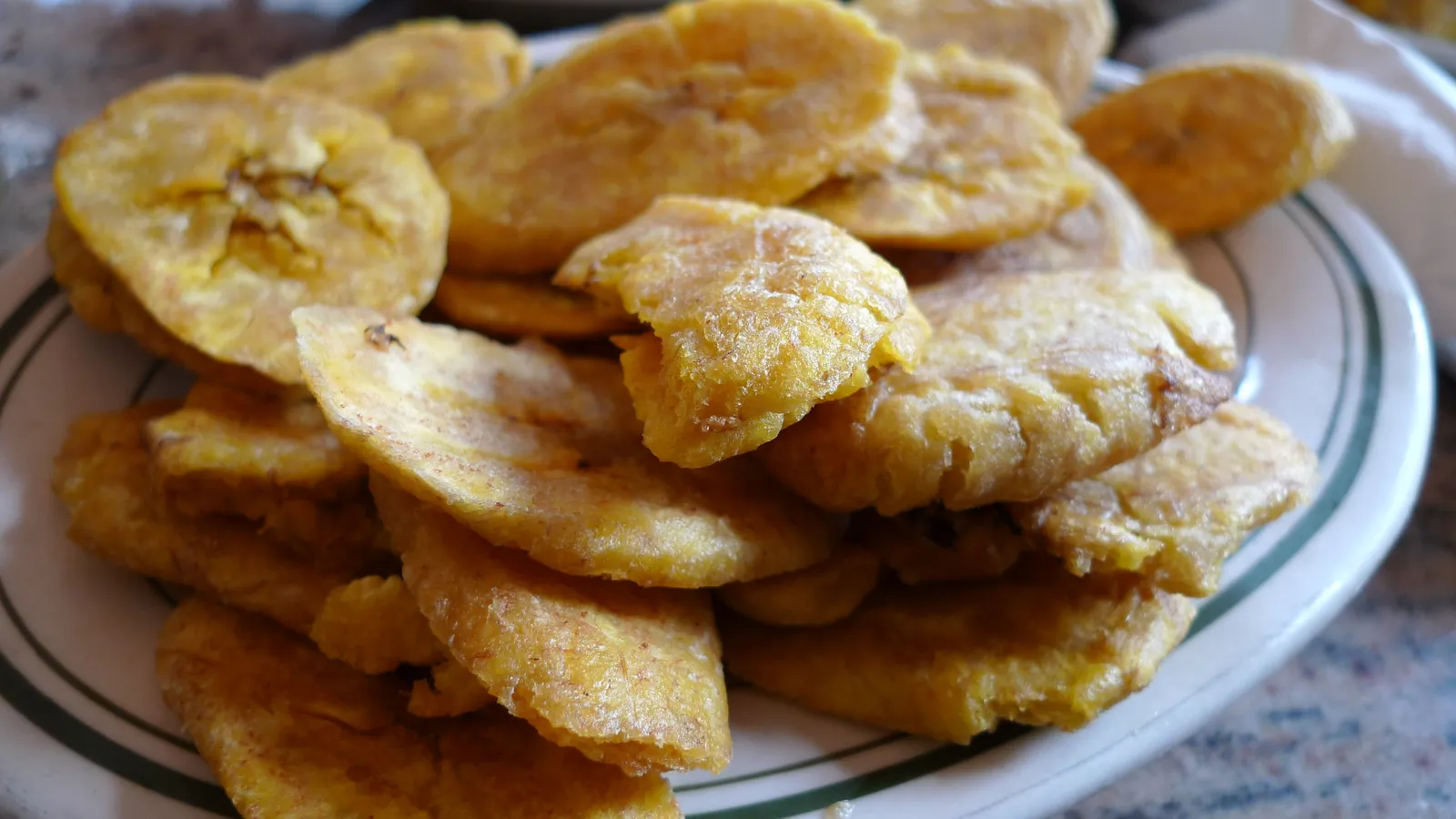 A plate of golden tostones, twice-fried plantains